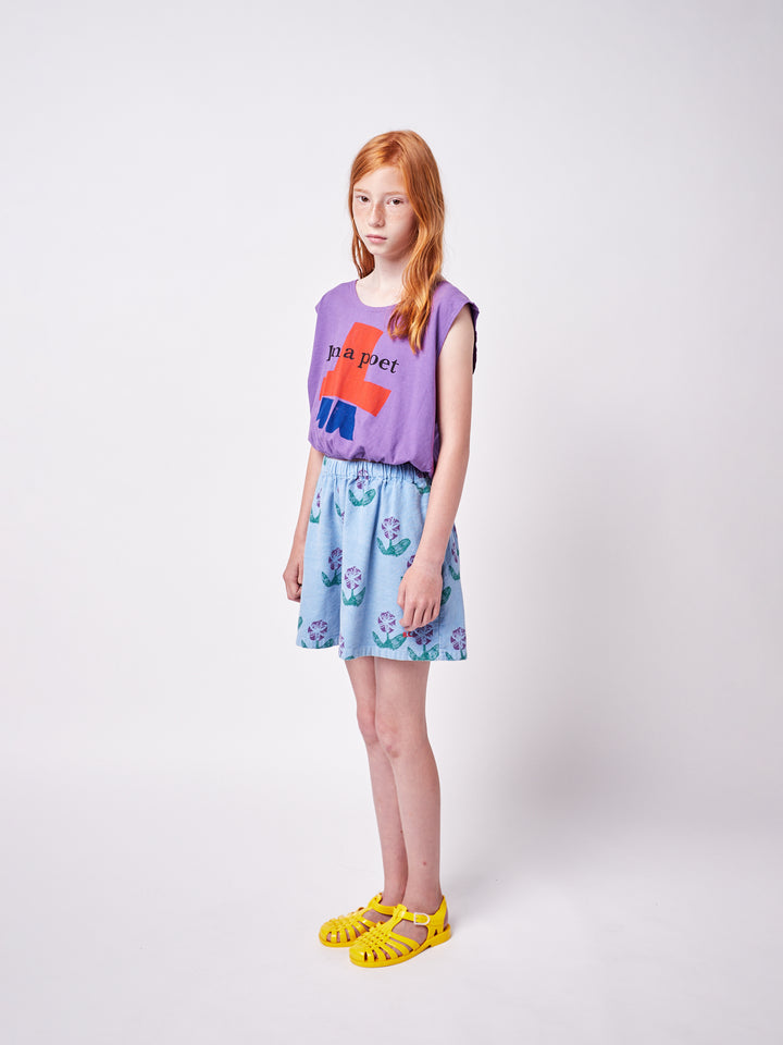 girl wearing Bobo Choses tee and blue woven culotte with purple floral print