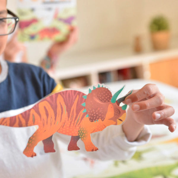 close-up of a kid holding a giant dinosaur sticker